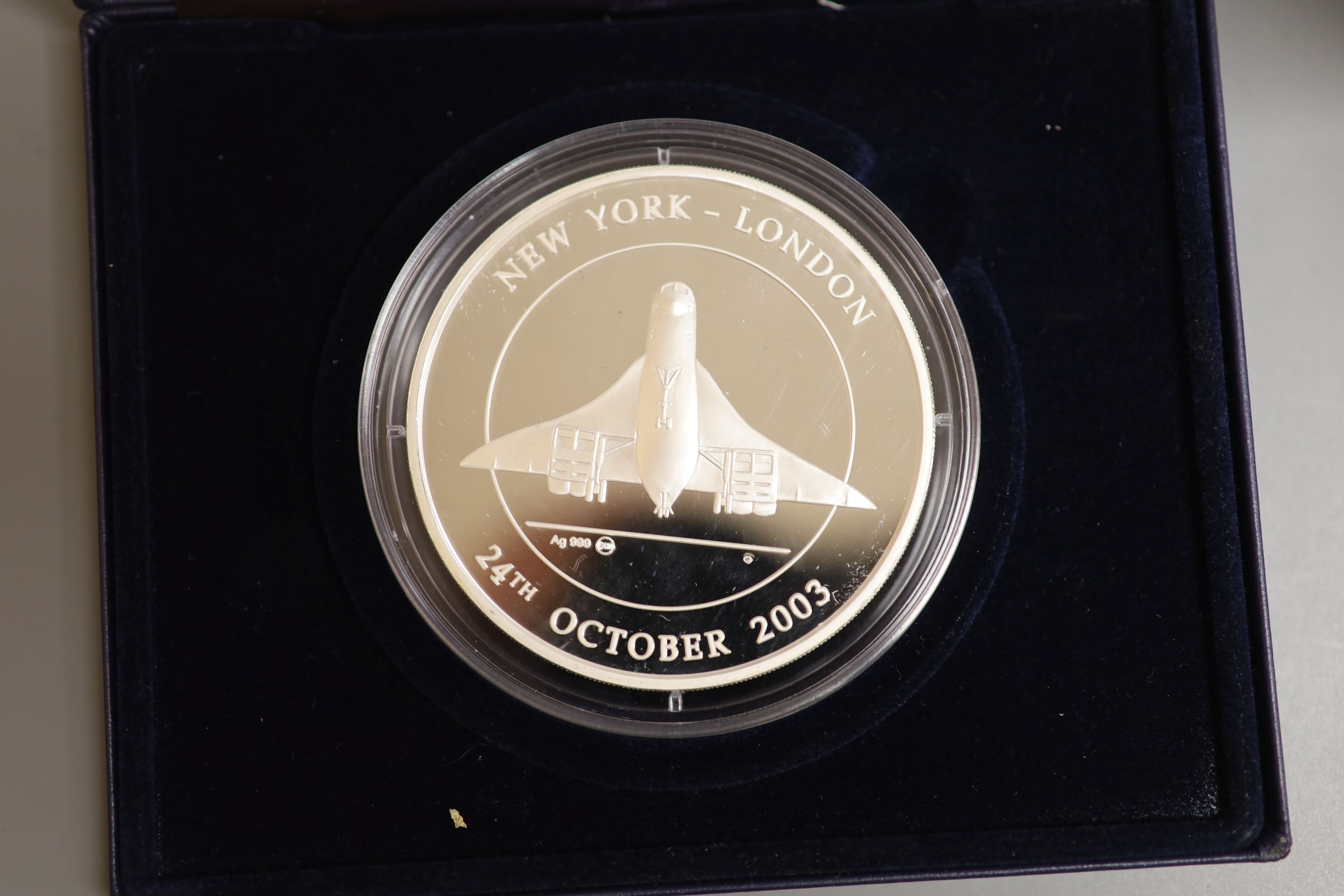 A Westminster 5 oz. proof silver concorde commemorative coin, 2003 and A Westminster the Beatrix Potter coin collection comprising six crowns 1993